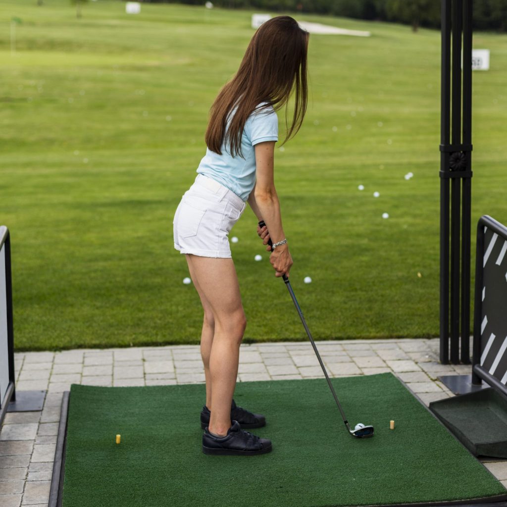 back-view-woman-practicing-golf-min